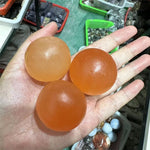 Orange selenite sphere