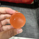 Orange selenite sphere