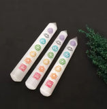 3 mineral wands with a pointed tip, with a polished surface. With engraved chakra symbols onto the wand.