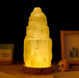 A prism lamp that sits on a wooden coaster. 
