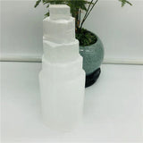 A crystal tower on a white table.