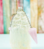 White crystal tower, holding a pendelum.