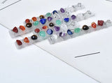 Handcrafted satin spar selenite sticks wire-wrapped with multi-colored gemstones like amethyst and jasper.